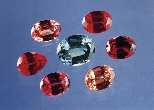 Figure 1. Russian crystal-growth laboratories are now producing hydrothermal synthetic ruby as well as sapphires in a range of colors. The bluegreen sapphire in the center (9.2 7.0 mm) weighs 2.65 ct.