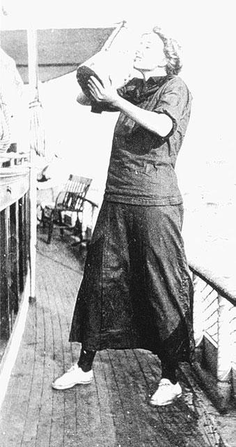 Frantic takes a drink, about 1910, wearing a dark version of the middy with a matching