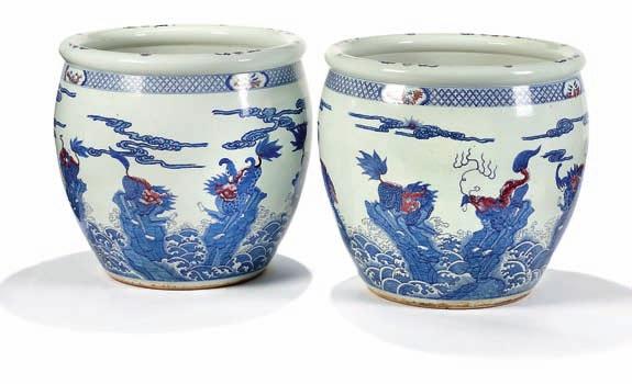 323 323 a pair of large porclain fish basins, decorated in underglaze blue and cobberred with kilin among clouds. China, 19th century. H.