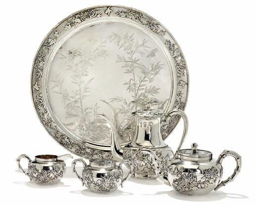 331 331 Chinese export silver tea service, engraved and applied with birds, bamboo and lotus flowers, bamboo shaped handles, comprising teapot, creamer, sugar bowl and tray.