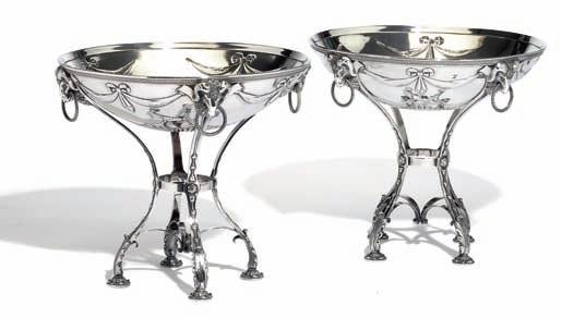 379 a pair of russian silver centerpieces with garlands, ring handles and ram heads. empire style. H. Bank, riga 1908-1917. Weight c. 3,440 gr. H. 25.5 cm. (2).