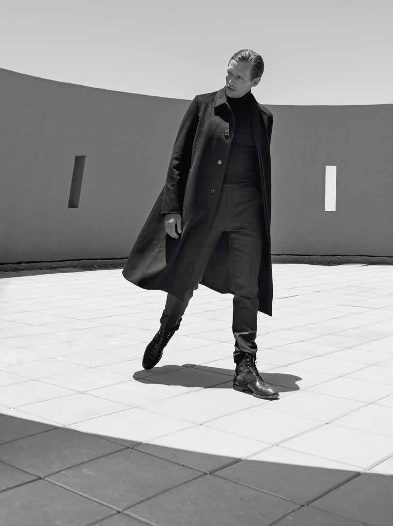 Black wool A-line coat, Dior Homme; black wool roll neck, Enlist; black wool trousers,