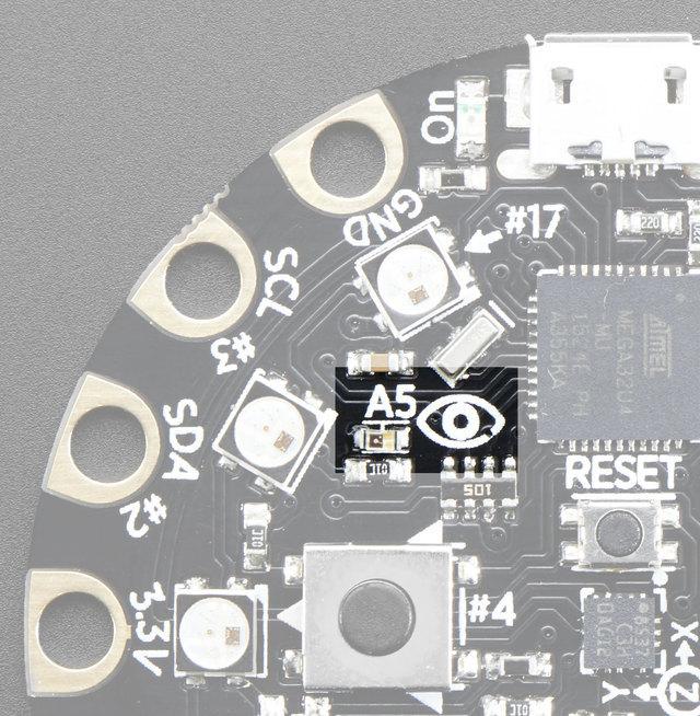 There is an analog light sensor, part number ALS-PT19 (http://adafru.it/n8f), in the top left part of the board.