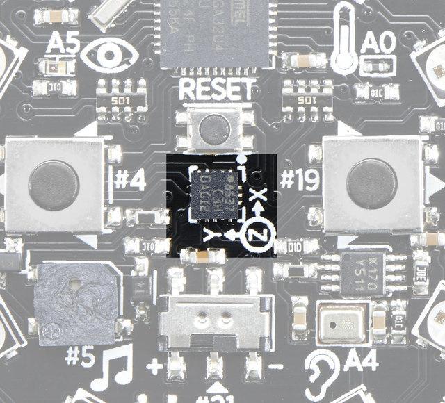 A LIS3DH 3-axis XYZ accelerometer is in the dead center of the board and you can use it to detect tilt, gravity, motion, as well as 'tap' and 'double tap' strikes on the board.