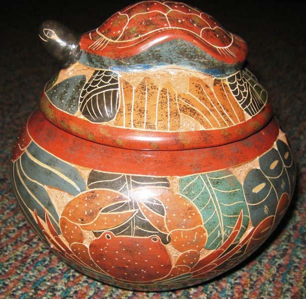 Examples of carved, painted and etched pottery: Figures are brightly painted by hand.