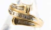 360. A 1980s gold and diamond dress ring, the crossover style tablet set with small baguette cuts, marked