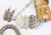 A group of silver and white metal jewellery, including a 1970s silver nurse s belt buckle, a leaf shape bracelet