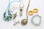 537. A collection of costume jewellery, including a 1977 silver ingot on chain, bead necklaces and more