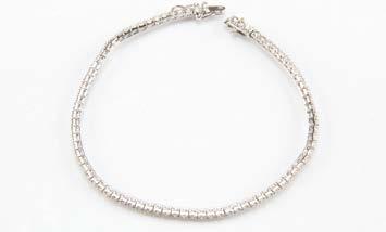 Lot 563 565. A modern 18ct white gold and diamond tennis bracelet, with over 2.