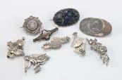 Eight Victorian and later silver and white metal brooches, together with a silver angel pendant (9) 60-80 576.