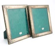A pair of modern silver photograph frames retailed by Harrods, 32cm high, with embossed floral design to rectangular frames (2) 83.