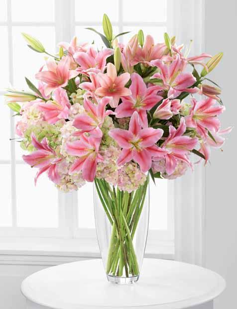 Flowers say it better. ftd says it best. extraordinary design A triumphant mix of exceptional lilies bursts from our towering glass vase.