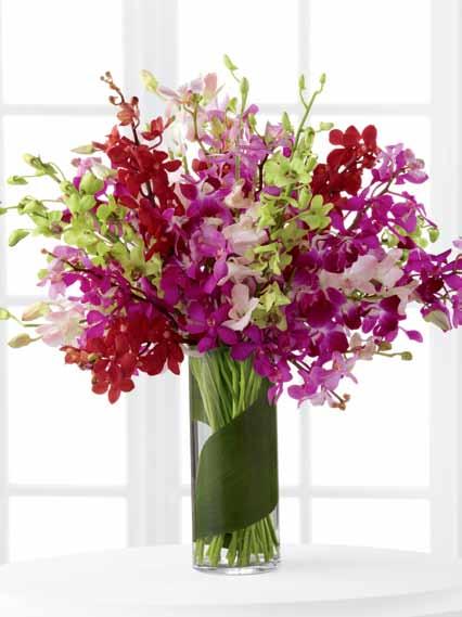 28"h x 32"w DELIVERED SRP $374.99 LX75 Capturing the beauty of the late afternoon sun, this exuberant orchid bouquet glows with color and elegance.
