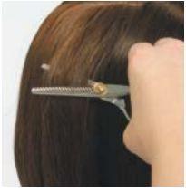 Move the shears through the hair, gently opening and partially closing the shears as you move, thus carving out areas. The more horizontal your shears, the more hair you remove.