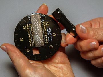 Test out your layers of velcro before adhering them. The finishing touch is to add the magnetic pin on the back of the NeoPixel ring board.