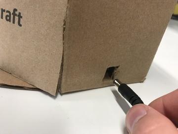 Cut a small square hole in the base of