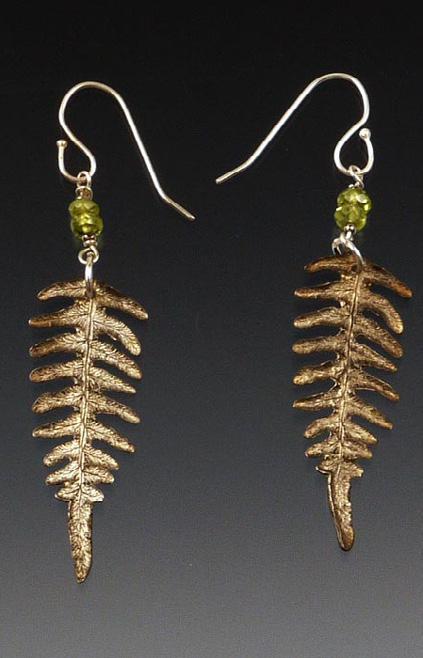 They are suspended from bronze french ear wires. This is the next size up from the petite. This style features the bracken fern in sterling silver with a warm bronze patina.