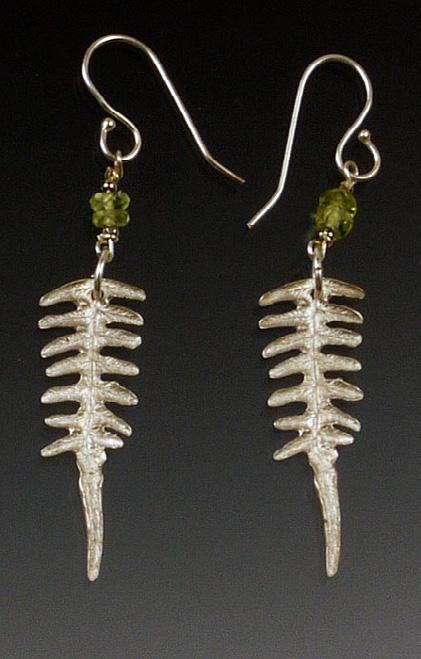 They are suspended from sterling ear wires. These delicate and original earrings feature the impression of a small bracken fern leaf in sterling silver with a warm bronze patina.