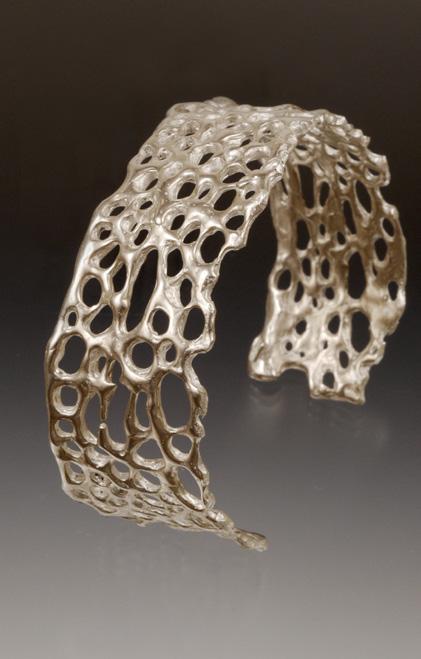 This stunning piece is in a bright silver finish. APPROX. 1 1/2 WIDE X 6 1/2 This delicate cuff bracelet is created from the skeleton of the prickly pear cactus.