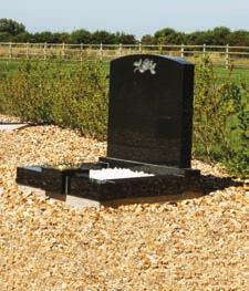 A small upright headstone and kerb set