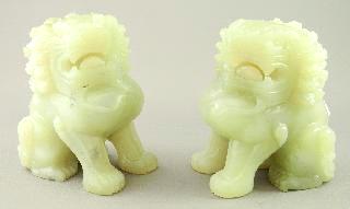 Lot # 499 499 Pair of carved celadon jade foo dogs.