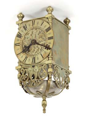 the painted dial supporting a thirty hour movement beneath a scroll arch pediment, full length trunk panel door, 209cm high 200-400 563 An 18th Century oak longcase clock, the arched hood surmounted