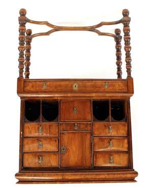 611 A Georgian mahogany satinwood strung and inlaid bureau, the fall front opening to reveal a fully fitted interior, drawers, pigeon-holes and secret compartments around a central cupboard above a