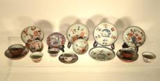 1166 SET OF MISMATCHED TEAWARE Ten ceramic saucers with a polychrome figurative decor.