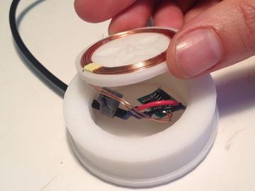 Pop the coil up through the 3d printed charging base ring and then onto the cap.