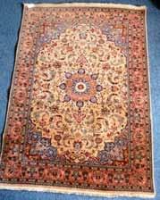 Lot 534 Lot 531 527 A large 20th Century hand knotted Persian Carpet, Islamic style turquoise blue central medallion against a red ground with varying repeating stylised flower heads and tendrils etc.
