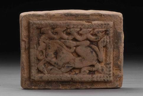 107. Inventory number: M34:13 Object title: Mould for ornament with horse design in bas-relief. Dimensions: Length 9.4cm; Width 7cm; Thickness 2-2.