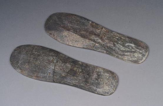 17. Inventory number: 710 Object title: Pair of shoe soles, grey jade. Dimensions: Length 23.9cm; Width (at broadest point) 7.6cm; (at narrowest) 5.6cm; Thickness 0.