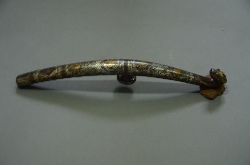 44. Inventory number: M15:3 Object title: Inlaid belt hook in the shape of a pipa (traditional Chinese musical instrument) Dimensions: Height 2.2cm; Width 1.3cm; Length 19.