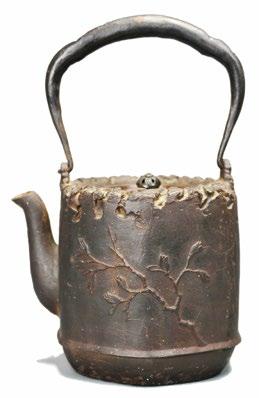 58 A Japanese Iron Teapot A Japanese Iron Teapot, octagonal body with straight sides and gently curving spout and handle, one side features a
