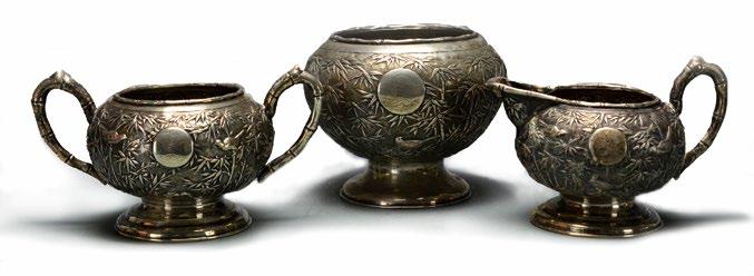 61 A Chinese Silver Tea Set A Chinese Silver Tea Set, 19th century, the tea set comprised of a creamer, sugar bowl and waste bowl, with bamboo leaf and bird meander, each with an S
