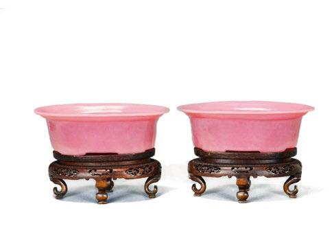 4 A Pair of Chinese Peking Pink Glass Dishes A Pair of Chinese Peking Pink Colored Glass Dishes, 19th century, oval shaped on wooden stands, straight high-sided