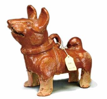 33 A Chinese Glazed Red Earthenware Dog, Han Dynasty A Chinese Glazed Red Earthenware Dog, Han Dynasty, the animal standing and facing forward with mouth open and ears raised, wearing a harness, his