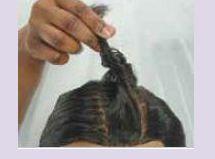 Starting at the hairline, part off a cornrow base in the desired direction. No extension is added at the starting point.