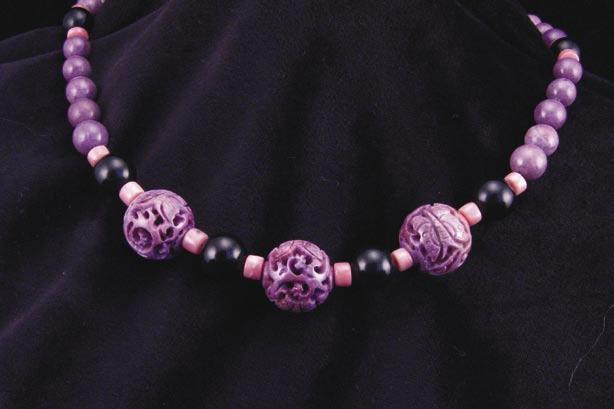 Hand carved natural un-enhanced purple jade beads are accented with pink opal and black jade in this exotic gemstone necklace.