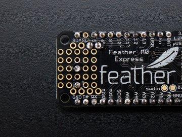 To verify you're connecting the right spots, place your sensor through the holes on the end of the Feather proto area, and make sure that you're