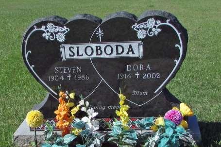 This stone on the south side of the cemetery features crosses (salvation), rose (love), grain (harvest; end of life; Christ), striking Ukrainian designs and inscription, along with a realistic