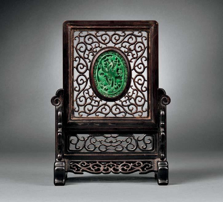 149 149 Wood Table Screen with Green Jade Inset, China, 19th/20th century, the screen mainly decorated with carved openwork scrolls, the oval jade with openwork decoration of a crane and fish on one
