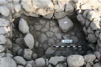 This locus is located below Locus 2048 and confined by wall W1000 and remains of other walls. It is a small room measuring 3X2.5 m and paved with coble stones.