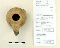 figurine, ivory bead and an intact Attic oil lamp (2 nd century BCE), with cream slip and burnish. Similar oil lamps are known from Egypt.