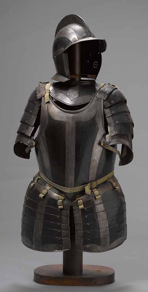 4019 A German black and white half-suit of armor late 16th/early 17th century Comprising: 1) Burgonet, two-piece skull with tall, roped comb; front edge flanged to form a pointed fall with turned
