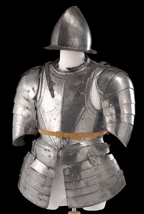4025 A German black and white half-suit of armor probably late 16th century Comprising: 1) Comb morion, two-piece skull with high roped rim, the sides molded with large fleur-de-lys in the style of