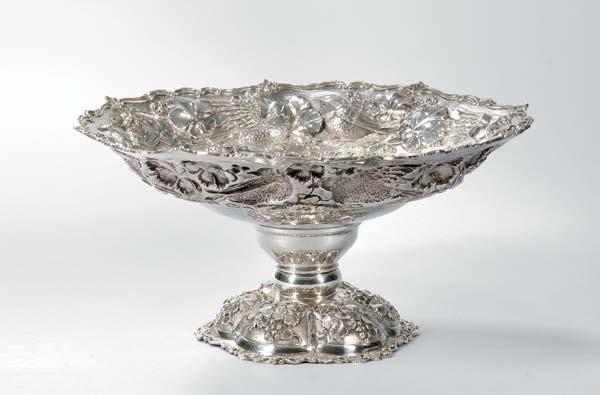 172 172 Neiman Marcus Sterling Silver Compote, probably South America, mid to late 20th century, the flared rim chased throughout with birds among grapevines on a short stem terminating in a lobed