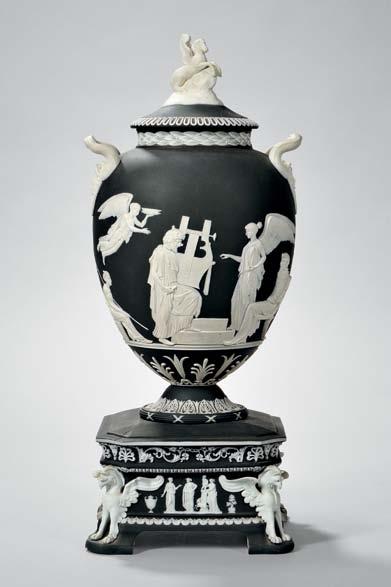 $600-800 308 Wedgwood Black Jasper Dip Apotheosis of Homer Vase and Cover, England, 19th century, applied white relief, the cover with Pegasus finial, the vase having Medusa mask and snake handles,