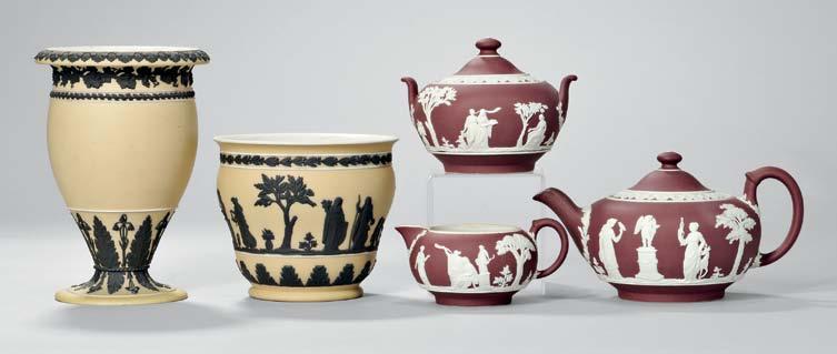 424 Three-piece Wedgwood Yellow Jasper Dip Tea Set, England, c. 1930, applied black jasper classical figures in relief, covered teapot, ht. 4 1/2; creamer, ht. 2 1/2; and covered sugar bowl, ht. 4 in.