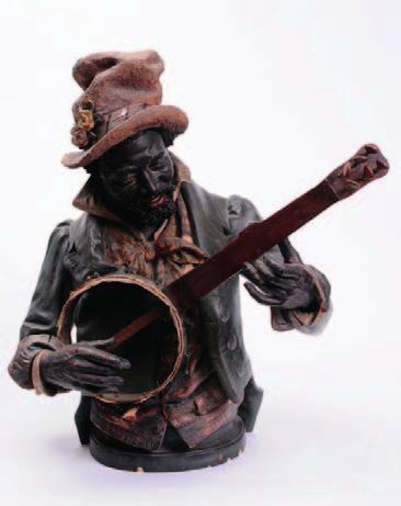 423 425 420 An Austrian cold painted terracotta figure of a negro banjo player modelled waist up wearing coat, waistcoat, scarf and hat and holding a banjo, on an oval base, 75cm high, late 19th or